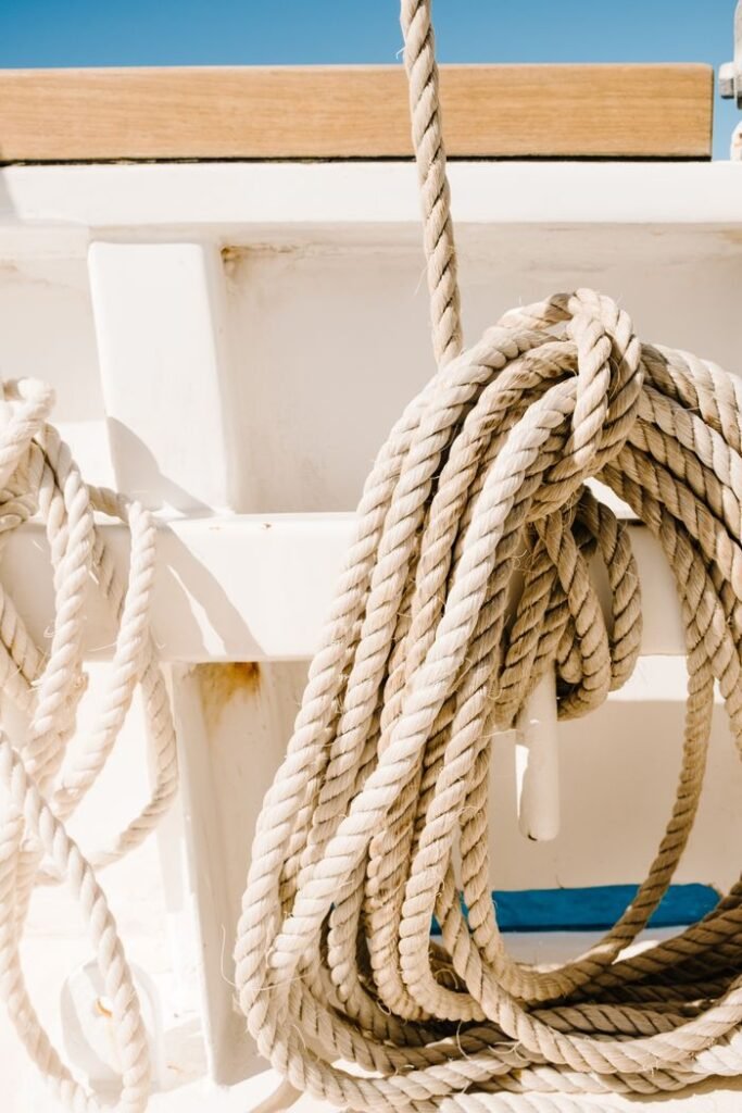 Detailed view of nautical ropes coiled on a boat deck under bright sunlight.